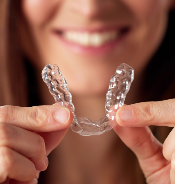 Smiling woman outside with healthy teeth